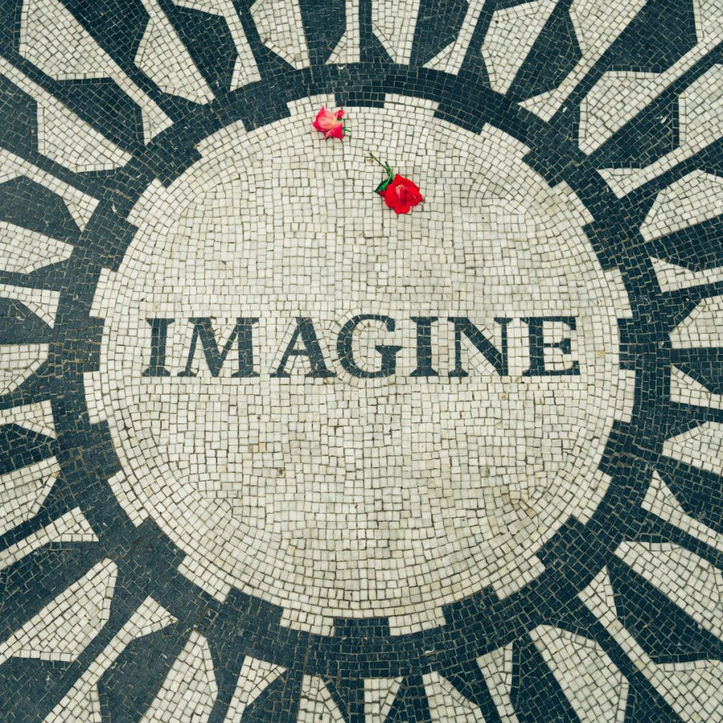 red rose on Imagine text with